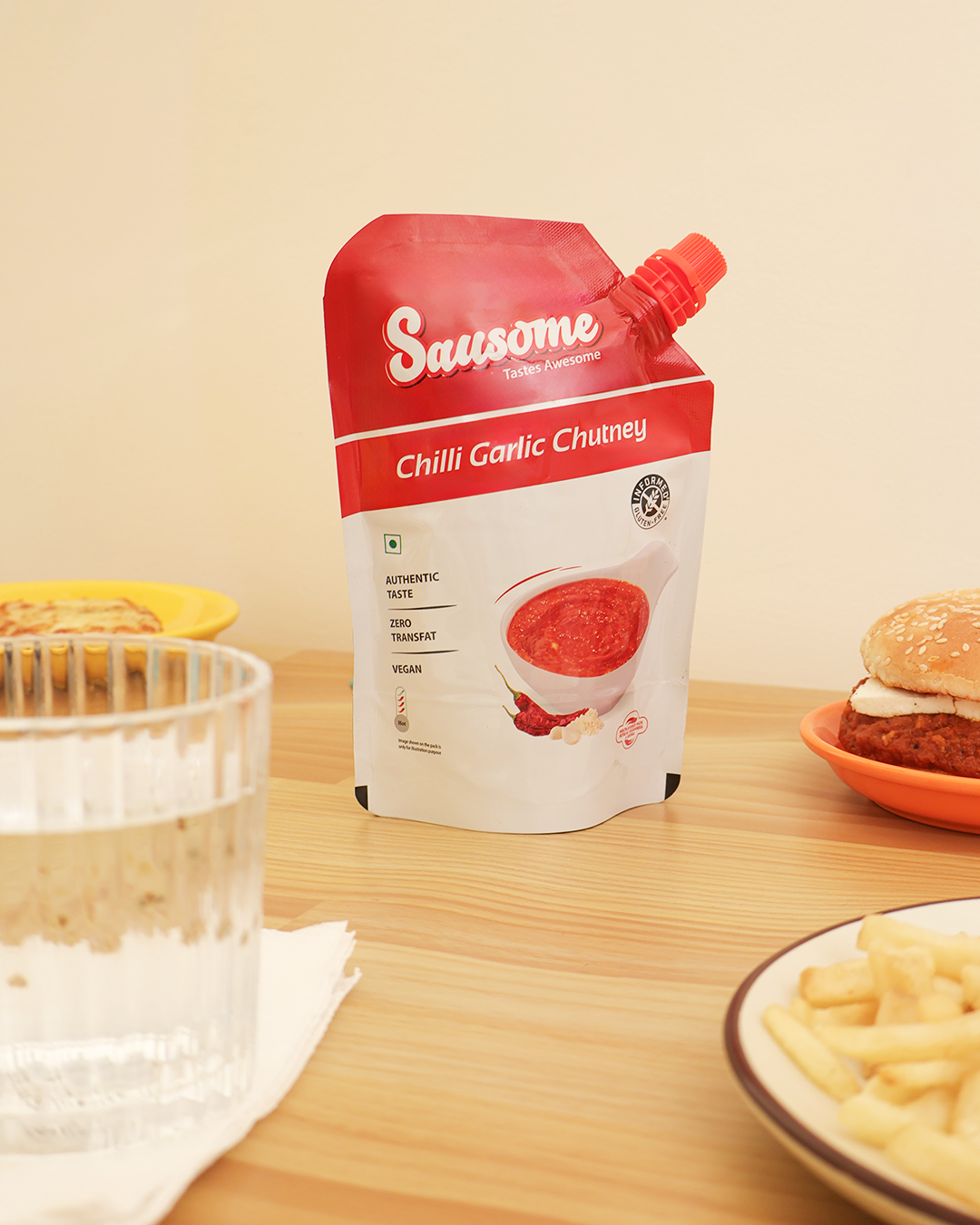 Sausome Chilli Garlic Chutney packet on a table with food items.