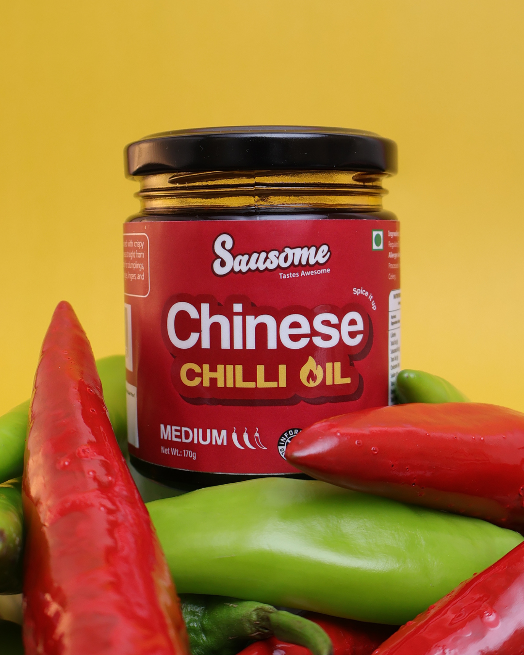 Jar of Sausome Chinese Chilli Oil with red and green peppers on a yellow background