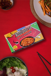 Noodleverse Spicy Korean noodle box on a red background with a salad and chopsticks.