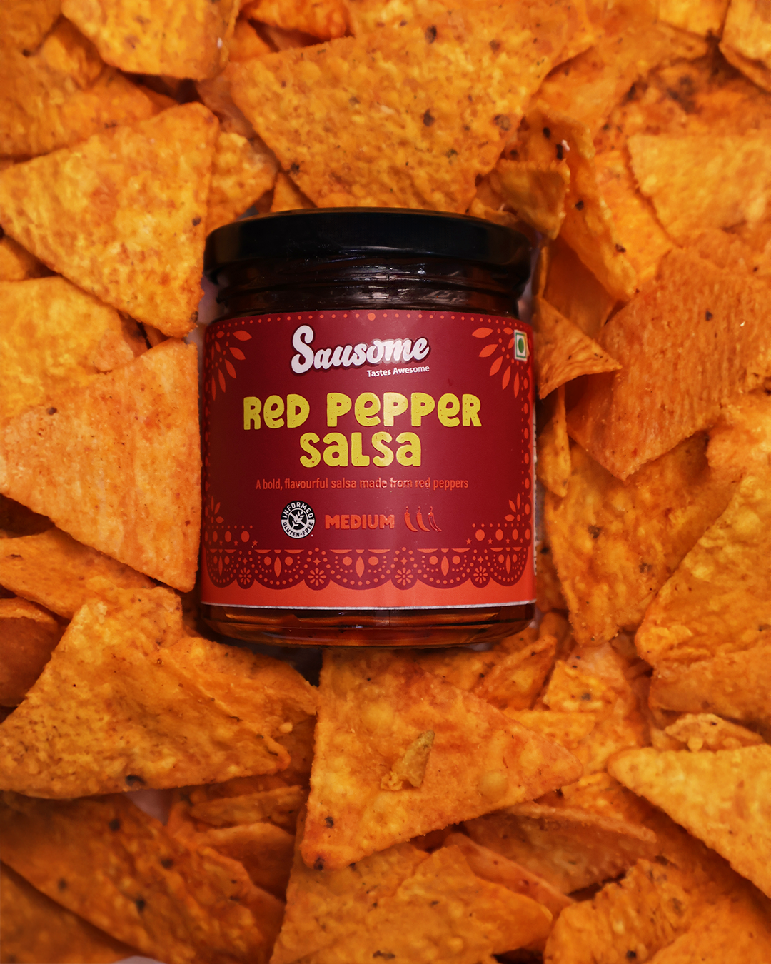 Jar of Sausome Red Pepper Salsa surrounded by tortilla chips