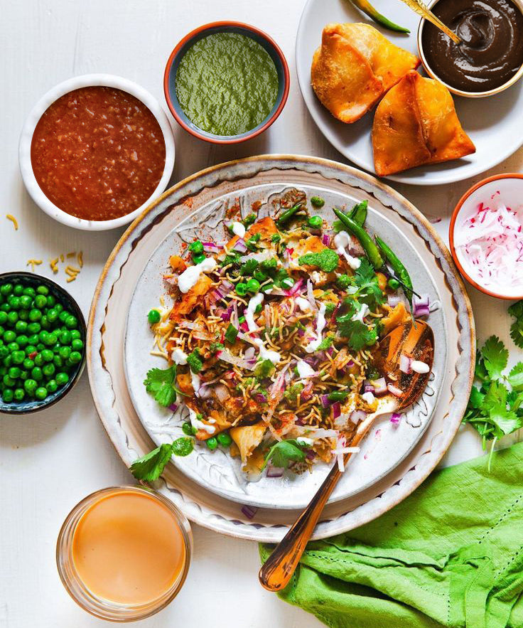 Plated dish with various ingredients and condiments on a white surface