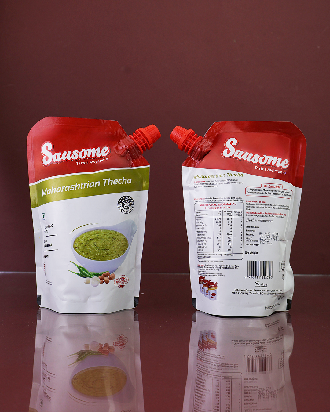 Two Sausome Maharashtrian Thecha pouches showing front and back placed on a reflective surface against a dark background