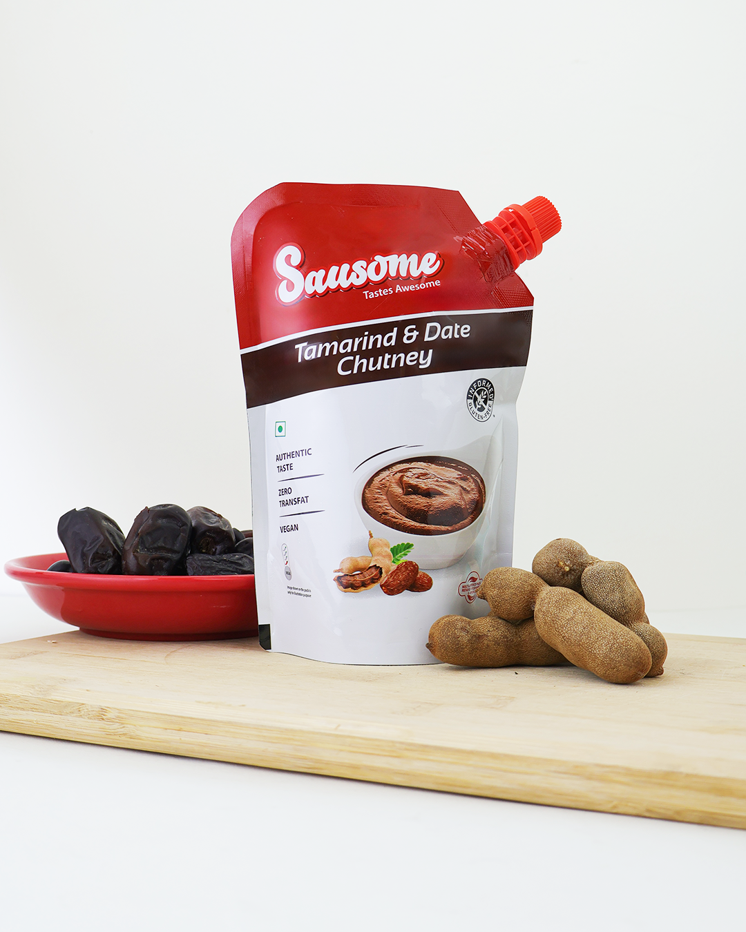 Sausome Tamarind & Date Chutney packaging with tamarind pods on a white background